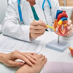Lekarz wyjaśnia pacjentowi budowę serca, omawiając wyniki EKG. Długie L4 to nie rozwiązanie, lepiej zadbać o zdrowie.