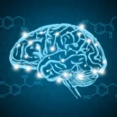 Błękitny mózg z błyskającymi punktami, otoczony wzorami chemicznymi. Ilustracja wyjaśnia, czym jest dopamina, kluczowy neuroprzekaźnik.