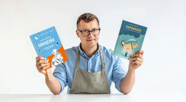 Mężczyzna w fartuchu trzyma dwie książki: "Gorączka. Przewodnik dla rodziców" i "Odporność. Czy Twoje dziecko może nie chorować?".